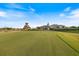 Scenic view of the golf course with lush green fairway and clubhouse in the background at 1298 Highland Greens Dr, Venice, FL 34285