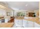 Bright kitchen showcasing granite countertops, white cabinetry, and views into the dining and living area at 1298 Highland Greens Dr, Venice, FL 34285