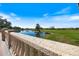 Close up view of a stone balustrade bordering the community golf course, a pond, and verdant lawns at 1298 Highland Greens Dr, Venice, FL 34285