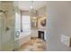 Bright main bathroom with a glass-enclosed shower, tub, and a vanity with dual sinks at 1298 Highland Greens Dr, Venice, FL 34285