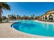 Expansive community pool with lounge chairs and umbrellas at 13238 Famiglia Dr, Venice, FL 34293