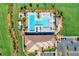 Overhead view of the community pool with lounge chairs, poolside bar, and lush landscaping at 13278 Huerta St, Venice, FL 34293