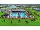 Aerial view of a beautiful pool and clubhouse in a lakeside residential community at 13278 Huerta St, Venice, FL 34293