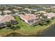 Aerial view of a home with a private screened-in patio and lake views at 13278 Huerta St, Venice, FL 34293