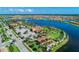 Aerial view of community amenities, clubhouse, parking, and lakefront property at 13278 Huerta St, Venice, FL 34293