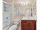 Traditional bathroom with a tiled shower and cherry vanity with sink at 13278 Huerta St, Venice, FL 34293