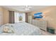 Bright bedroom features a comfortable bed, a large window, and neutral decor for a peaceful retreat at 13278 Huerta St, Venice, FL 34293