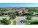 Community center with beautiful landscaping, palm trees, and pristine grounds at 13278 Huerta St, Venice, FL 34293