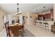 Cozy dining area featuring a rustic wooden table, bar seating, and an inviting atmosphere for gatherings at 13278 Huerta St, Venice, FL 34293