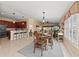 Open-concept dining area with stylish furnishings and a seamless flow to the kitchen and living spaces at 13278 Huerta St, Venice, FL 34293