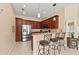 Modern kitchen features dark cabinets, stainless steel appliances, and breakfast bar seating for casual dining at 13278 Huerta St, Venice, FL 34293