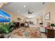 Spacious living room with plush seating, floral rug, and seamless flow to other living spaces at 13278 Huerta St, Venice, FL 34293