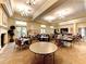 Spacious meeting room with tables, chairs, and natural light, perfect for gatherings and community events at 13278 Huerta St, Venice, FL 34293