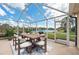 Enclosed patio with outdoor seating offers picturesque lake views for relaxing or dining at 13278 Huerta St, Venice, FL 34293