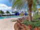 Resort-style pool surrounded by lush landscaping, lounge chairs, and umbrellas for ultimate relaxation at 13278 Huerta St, Venice, FL 34293