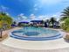 Inviting pool with fountains, sun loungers, and palm trees, creating a tropical oasis for residents at 13278 Huerta St, Venice, FL 34293