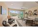 The sunroom features a ceiling fan and lovely views of the water at 13278 Huerta St, Venice, FL 34293