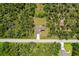 An aerial view shows a home surrounded by beautiful Florida foliage at 13341 Drummond Ave, Port Charlotte, FL 33953