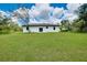 Large, well-maintained backyard featuring a lush lawn and mature trees at 13341 Drummond Ave, Port Charlotte, FL 33953