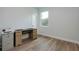 Spare bedroom with light wood floors, light blue walls, and a desk by the window at 13341 Drummond Ave, Port Charlotte, FL 33953