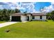 An inviting single-story home boasting a well-maintained lawn and classic architectural design at 13341 Drummond Ave, Port Charlotte, FL 33953