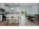 Well-lit kitchen featuring white cabinets, stainless steel appliances, and a large island with modern seating at 13341 Drummond Ave, Port Charlotte, FL 33953