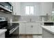 Close up on white kitchen cabinets, subway tile backsplash, and stainless steel appliances at 13341 Drummond Ave, Port Charlotte, FL 33953