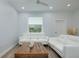 Inviting living area with white sofas, a wood coffee table, and natural light at 13341 Drummond Ave, Port Charlotte, FL 33953