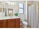 Bathroom featuring a vanity with a sink, a large mirror, and a shower with a striped curtain at 1342 Maseno Dr, Venice, FL 34292
