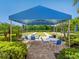 Outdoor setup with tables, chairs, and shelter near the bocce courts provides a comfortable recreational space at 1342 Maseno Dr, Venice, FL 34292