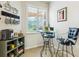 Breakfast nook with a glass table, two chairs, plantation shutters and decor at 1342 Maseno Dr, Venice, FL 34292