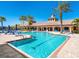 Large community pool with palm trees and lounge chairs, offering a resort-style oasis for residents to relax and enjoy at 1342 Maseno Dr, Venice, FL 34292