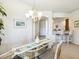 Bright dining room with modern chandelier, bar access, and view to the kitchen at 1342 Maseno Dr, Venice, FL 34292