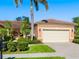 Charming single-story home boasting a tile roof, manicured lawn, and a two-car garage at 1342 Maseno Dr, Venice, FL 34292