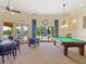 Game room with pool table, card table, and a view of the pool area at 1342 Maseno Dr, Venice, FL 34292