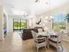 Bright living room with tile flooring, sliding glass doors, and a comfortable seating area at 1342 Maseno Dr, Venice, FL 34292