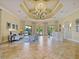 Clubhouse lobby area with a chandelier, reception desk, seating, and view of the pool at 1342 Maseno Dr, Venice, FL 34292
