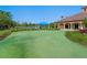 Backyard putting green by the lake, perfect for practicing golf skills and enjoying waterfront living at 1342 Maseno Dr, Venice, FL 34292