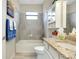 Bathroom featuring a bathtub, granite countertops, and vanity with storage at 13730 Vancanza, Venice, FL 34293