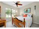 Bedroom with a wooden bed frame and lots of natural light from the window at 13730 Vancanza, Venice, FL 34293
