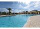 Inviting community pool area surrounded by palm trees, lounge chairs, and well-maintained landscaping at 13730 Vancanza, Venice, FL 34293