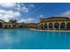 Expansive community pool with ample seating, a resort-style atmosphere, and beautiful landscaping at 13730 Vancanza, Venice, FL 34293