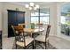 Cozy dining area with an elegant light fixture and stylish black accent cabinet at 13730 Vancanza, Venice, FL 34293
