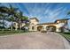 Grand gated entrance to a community with manicured landscaping and beautiful architecture at 13730 Vancanza, Venice, FL 34293