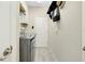 Well-lit laundry room with gray tile floors and modern washer and dryer at 13730 Vancanza, Venice, FL 34293