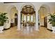 Elegant lounge featuring decorative columns, tray ceiling, travertine flooring, a fireplace, and plenty of seating at 13730 Vancanza, Venice, FL 34293