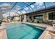 Inviting screened-in pool featuring ample patio space and cozy outdoor seating at 13730 Vancanza, Venice, FL 34293
