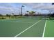 Well-maintained community tennis court with new netting, lighting, and a surrounding fence at 13730 Vancanza, Venice, FL 34293