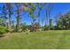 A generous lot with a well-manicured lawn and views of surrounding trees at 1449 Overhead St, North Port, FL 34288
