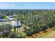 Scenic aerial view of a well-maintained lawn and the neighboring forest at 1449 Overhead St, North Port, FL 34288